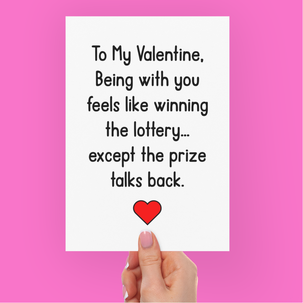 Hand holding a Valentine's Day card with humorous message on a pink background