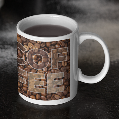 Mug with coffee-themed design on a kitchen counter with pastries and a muffin tin.