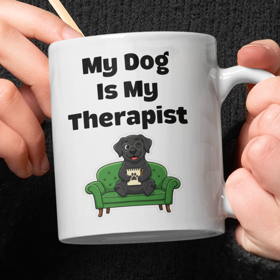 Person holding a mug with 'My Dog is My Therapist' text and a dog illustration.