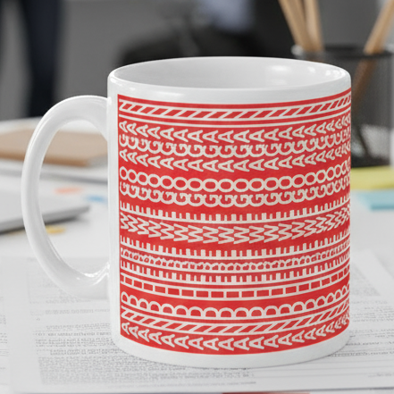 White mug with red geometric pattern on a white background