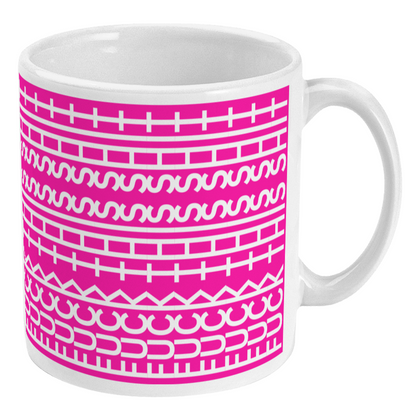 White mug with pink geometric pattern on a white background