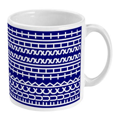 White mug with blue geometric pattern on a white background