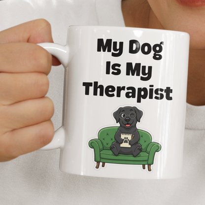 Person holding a mug with 'My Dog is My Therapist' text and dog illustration.