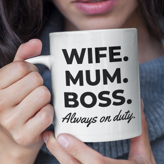 Woman holding a mug with text 'WIFE. MUM. BOSS. Always on duty' in a casual setting.