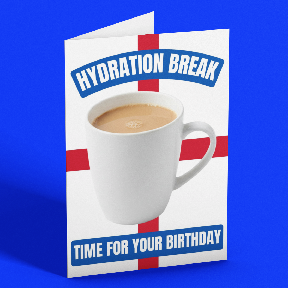 A folded greeting card standing upright on a bright blue background. The card features a white mug of coffee on a red cross design, with the text 'HYDRATION BREAK' at the top and 'TIME FOR YOUR BIRTHDAY' at the bottom.
