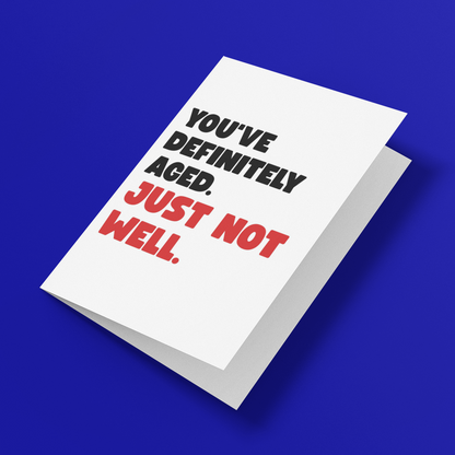 A white greeting card with bold text reading 'YOU'VE DEFINITELY AGED. JUST NOT WELL.