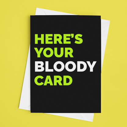 A black greeting card with the text 'HERE'S YOUR BLOODY CARD' in bright green and white lettering, shown with a white envelope on a solid yellow background.