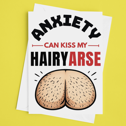 A white art print featuring the humorous text 'ANXIETY CAN KISS MY HAIRYARSE' with an illustration of a hairy butt, displayed on a bright yellow background.