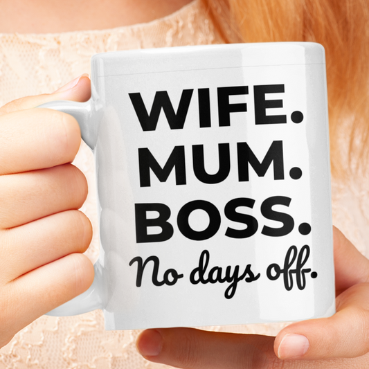 Person holding a mug with 'WIFE. MUM. BOSS. No days off' text against a neutral background