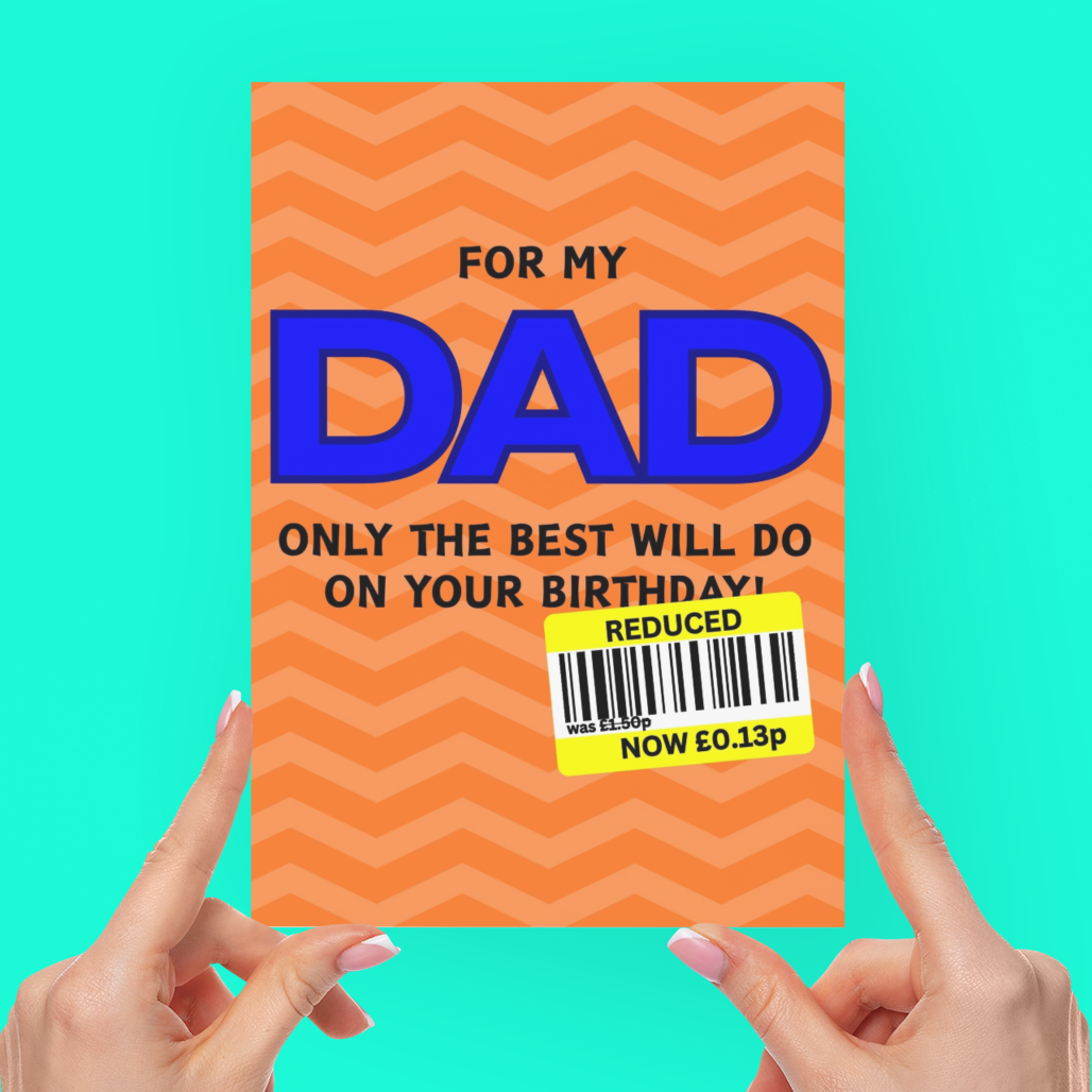 A person's hands holding a novelty orange greeting card with a wavy pattern, featuring the text 'FOR MY DAD ONLY THE BEST WILL DO ON YOUR BIRTHDAY!' and a yellow 'REDUCED!' barcode sticker, against a solid turquoise background.