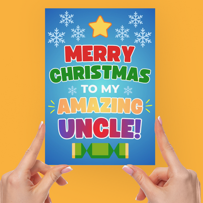 A person holds a colorful Christmas greeting card that reads 'MERRY CHRISTMAS TO MY AMAZING UNCLE!' against a solid orange background.