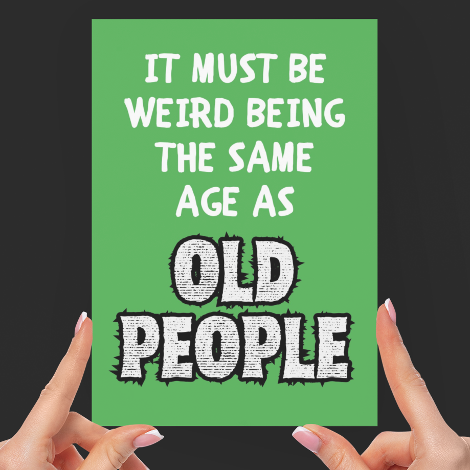 Green card with humorous text held by hands against a black background