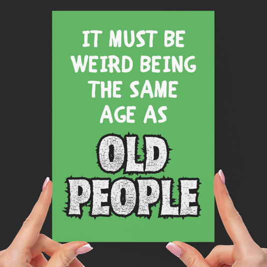 Green card with humorous text held by hands against a black background