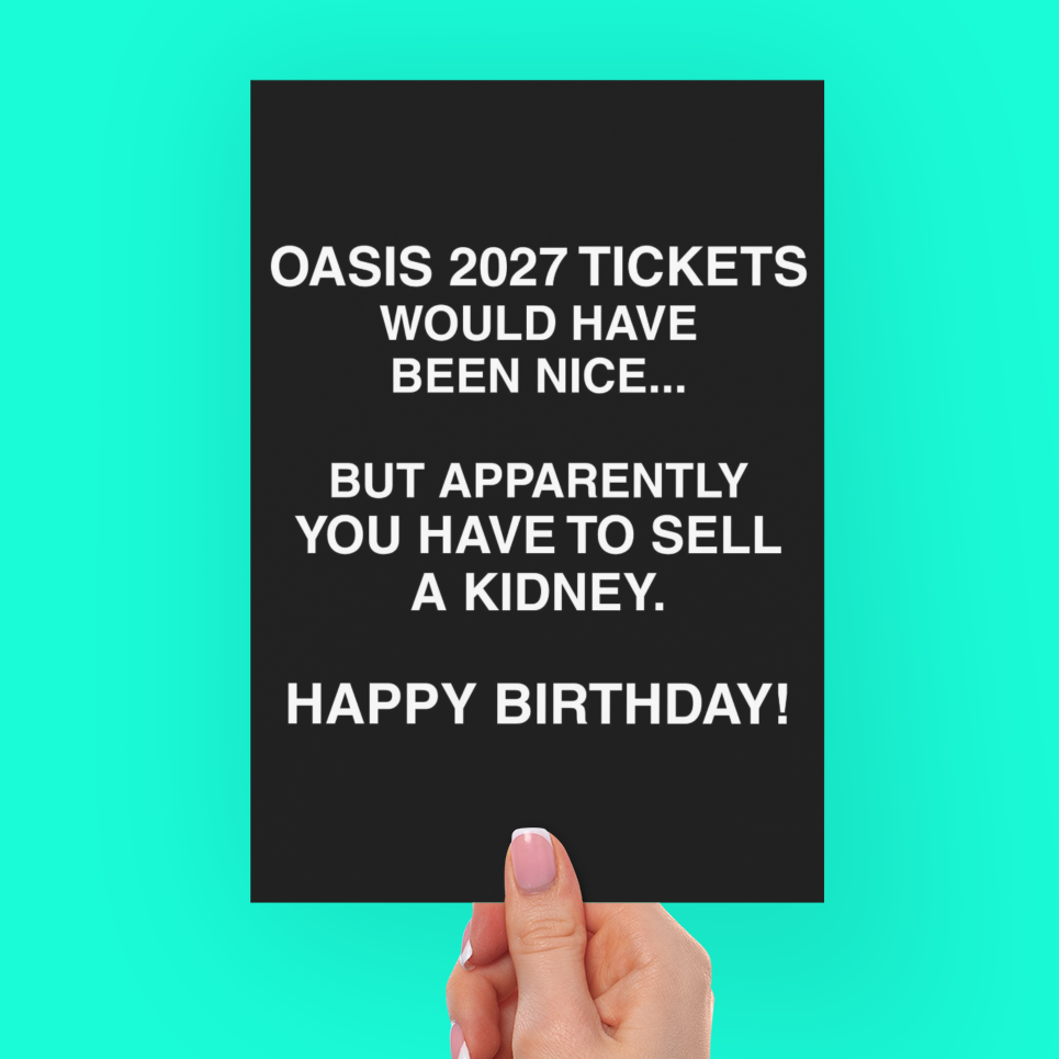 A hand holding a black rectangular card with white text that reads, 'OASIS 2027 TICKETS WOULD HAVE BEEN NICE.