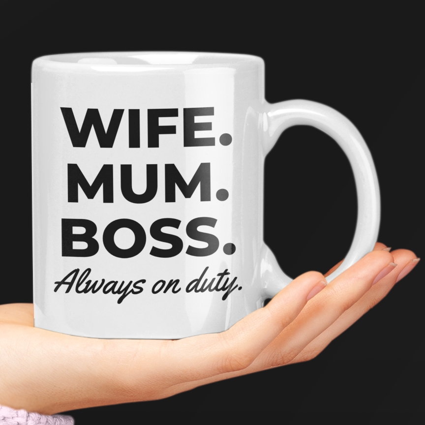 White mug with text 'Wife. Mum. Boss. Always on duty.' held by a hand against a black background